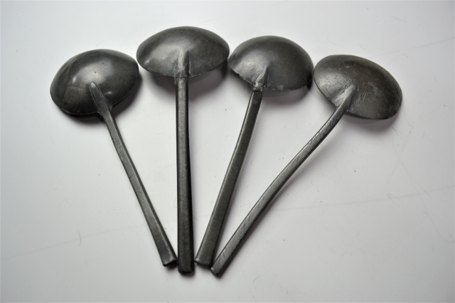 18th century spoon rack with pewter spoons.