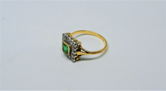 An 18ct Gold Emerald And Diamond Cluster Ring.