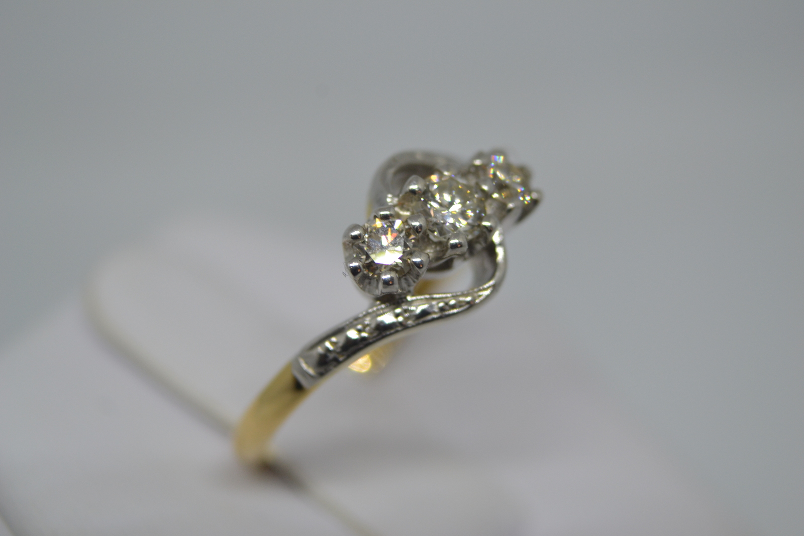 A Three Stone Diamond Cross Over Ring