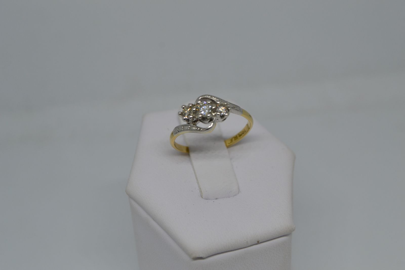 A Three Stone Diamond Cross Over Ring